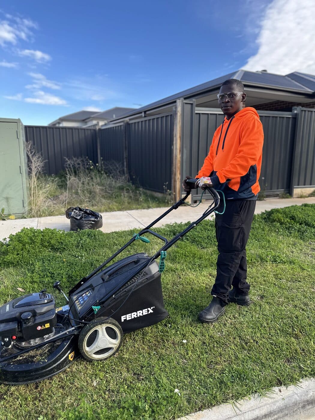 Special Lawn Forces crew member mowing a lawn